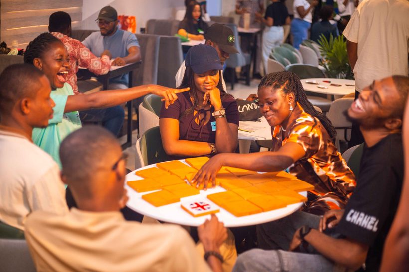 Community members laughing and playing a group game together at a meetup