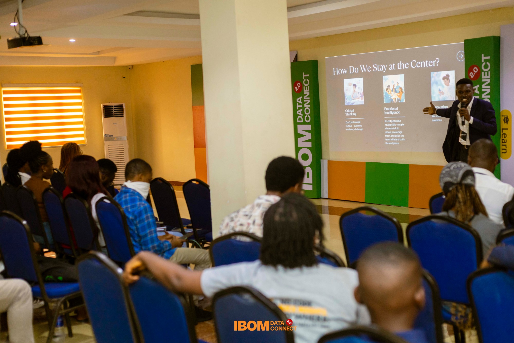 A speaker presenting to attendees at Ibom Data Connect 2.0